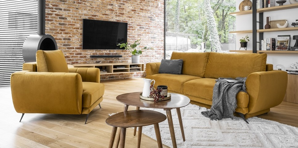 A loft lounge with a sofa and an armchair